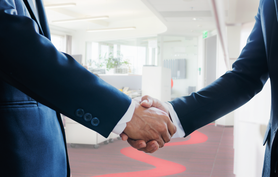 Handshake in a professional office with red accents