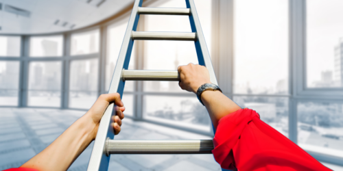 Person climbing a ladder in a professional corner office